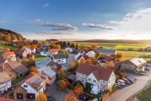 A range of houses in the coutryside at sunrise.